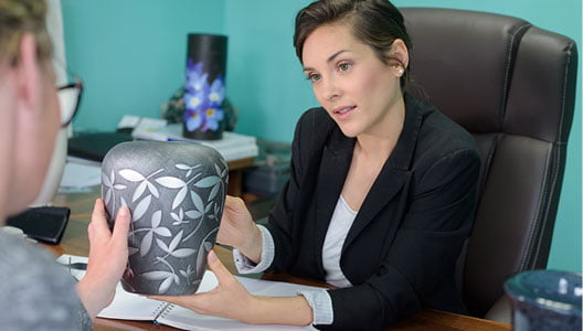 How To Adapt To Rising Cremation Trends 3 woman holding urn